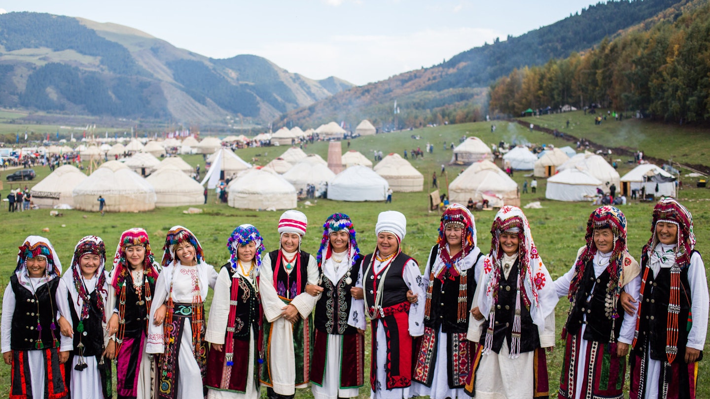 Southern Kyrgyzstan women in traditional dress at the World Nomad Games yurt camp at Kyrchyn Jailoo © Stephen Lioy / Lonely Planet