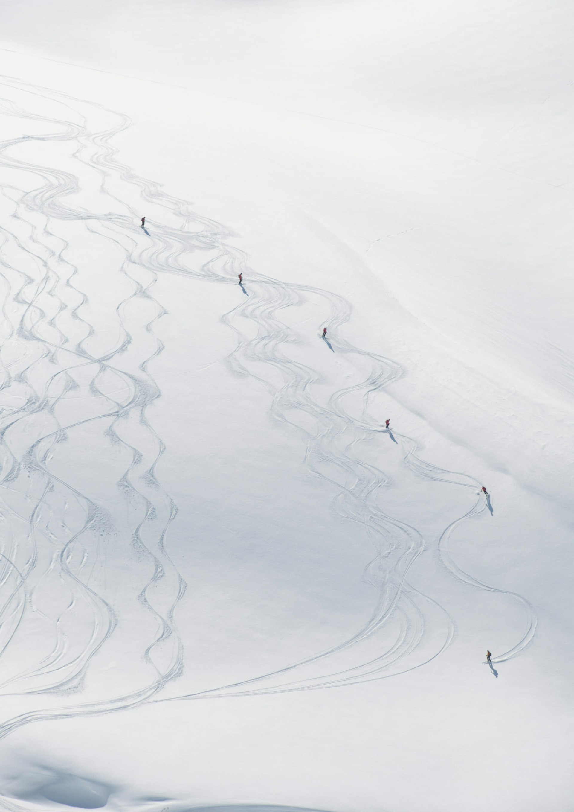 Skiers cut runs down a snowy mountain in Val-d'Isère, France © James D. Morgan/Getty Images