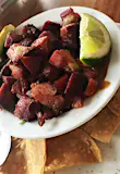 Chifrijo is a typical Costa Rican dish made with pork, beans, rice and pico de gallo and is a popular dish at La Oveja Negra Restaurant Maria Esther Abissi / Lonely Planet