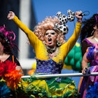 Three brightly clothed individuals celebrate Pride in Sao Paulo