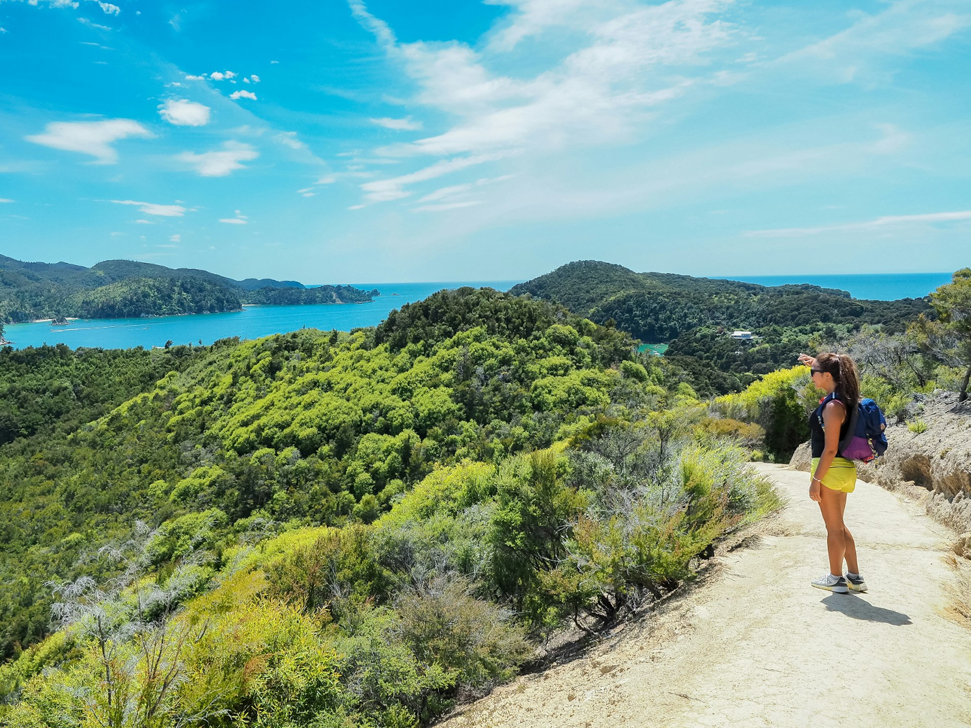 A woman pauses to take in the view along the Abel Tasman Coast Track, Tasmania