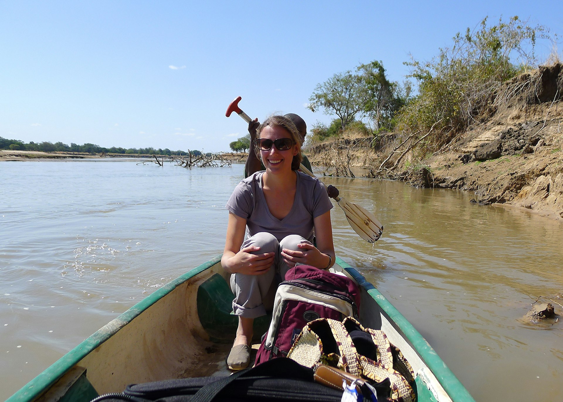 Elizabeth Gordon in a canoe on a river in Zambia, Africa © Elizabeth Gordon