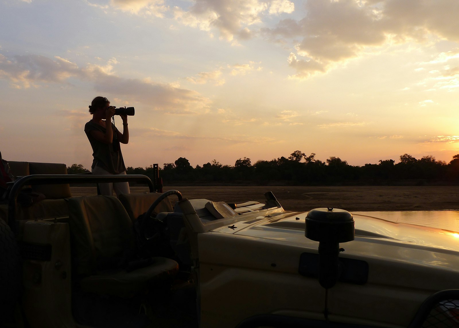 Elizabeth Gordon taking photographs of landscape at dawn in Zambia © Elizabeth Gordon 