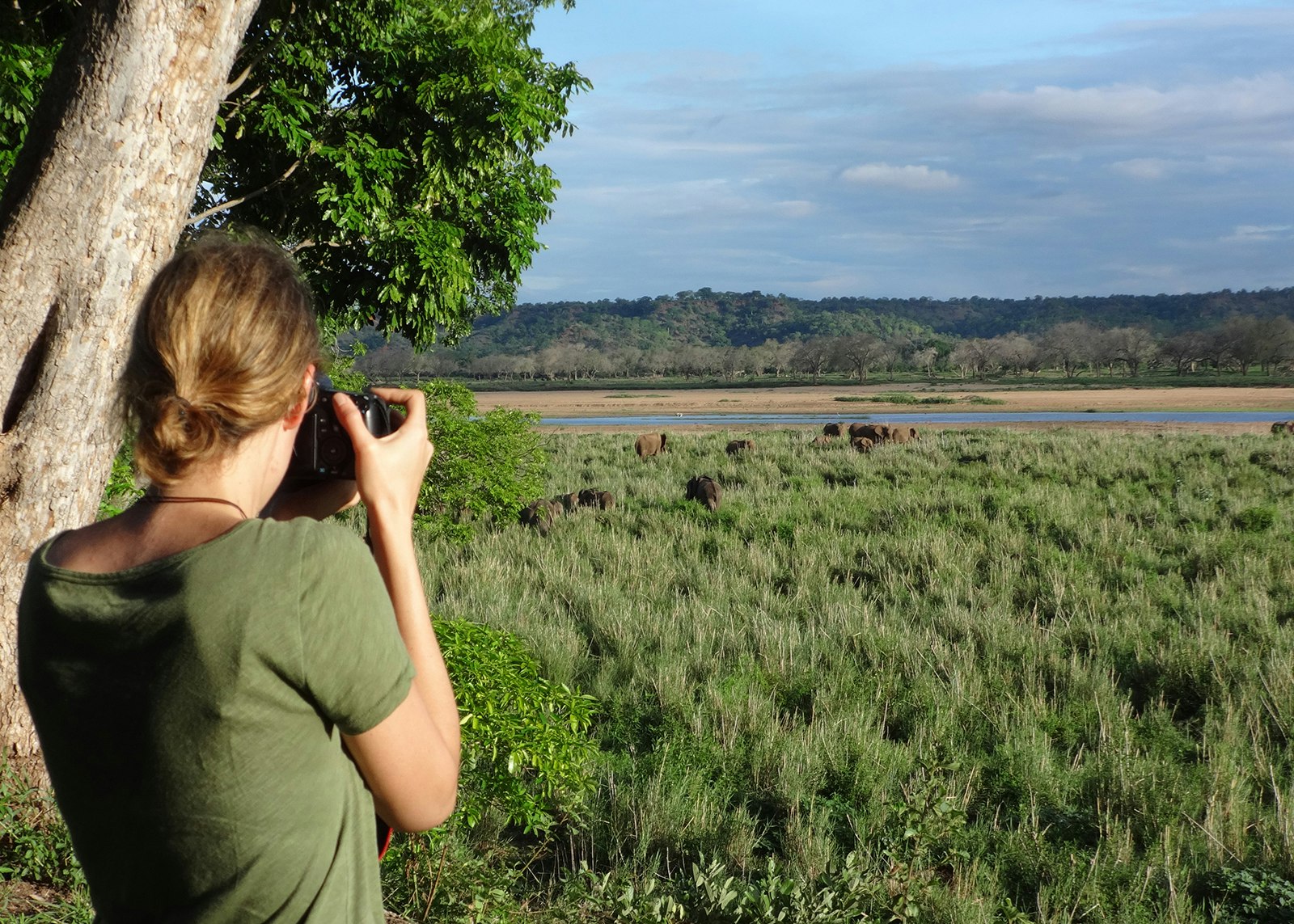Elizabeth Gordon taking photos of elephants at waterhole in Africa © Elizabeth Gordon