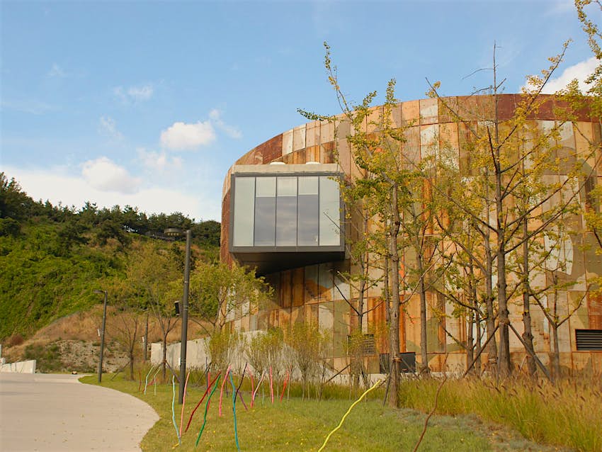 Features - Check out a free art exhibition or concert at Culture Tank © Hahna Yoon / Lonely Planet A converted brown and tan oil tank with a window built into it and pathway leading up to it. Check out a free art exhibition or concert at Culture Tank © Hahna Yoon / Lonely Planet