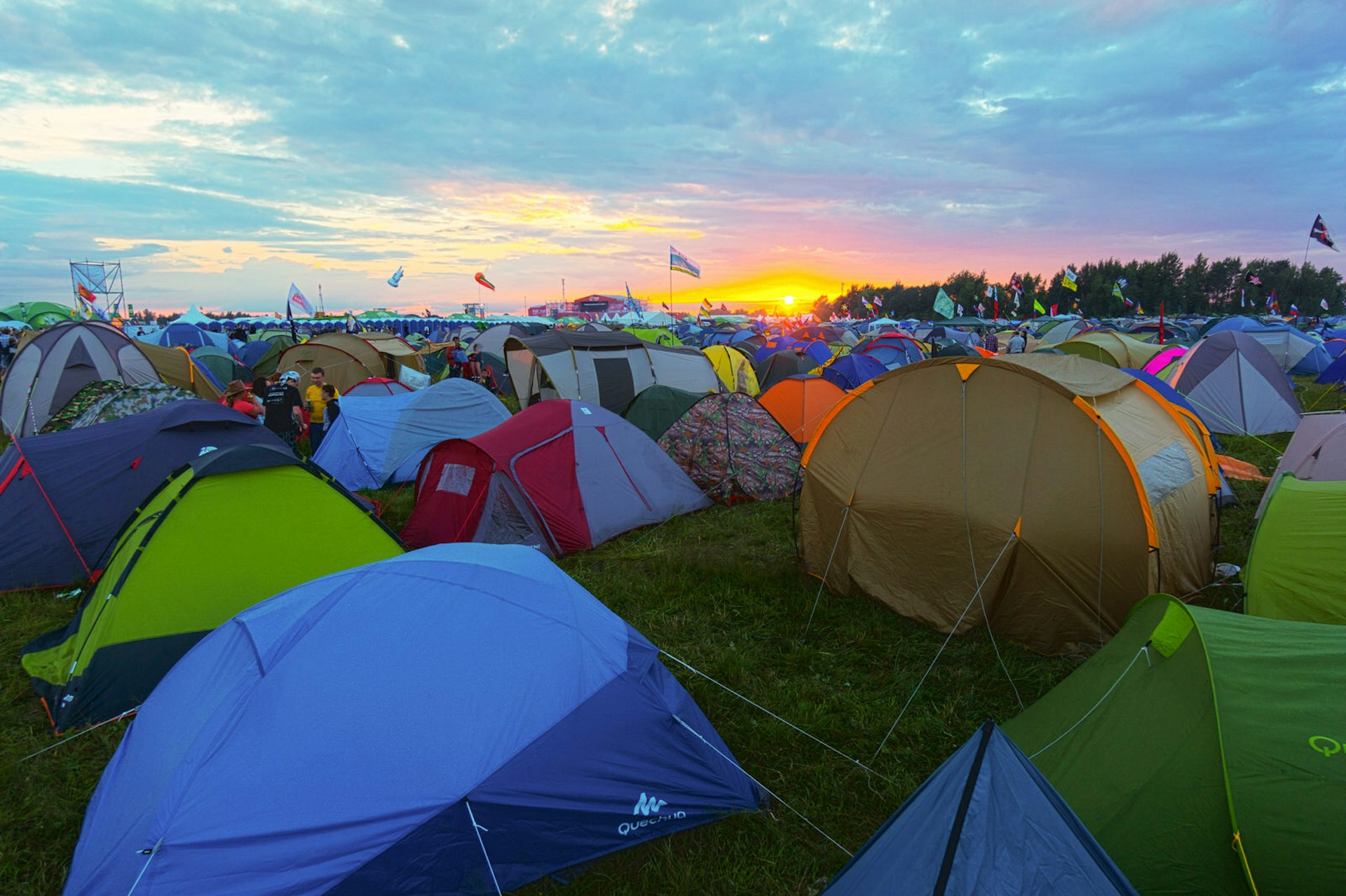 A field full of tents at a festival at sunset © Anton Gvozdikov / Shutterstock