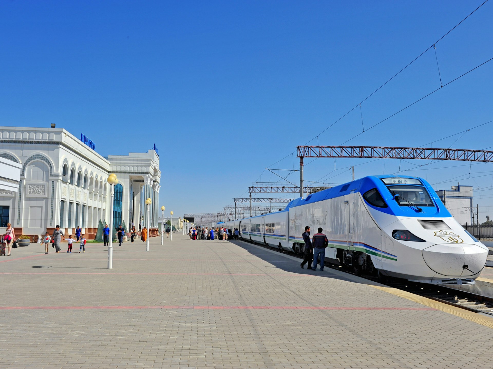 A blue and white long-nosed train stands on the platform at a white train station building. Bukhara station: the high-speed train line linking Bukhara and Samarkand opened in 2016 © Julia Drugova / Shutterstock