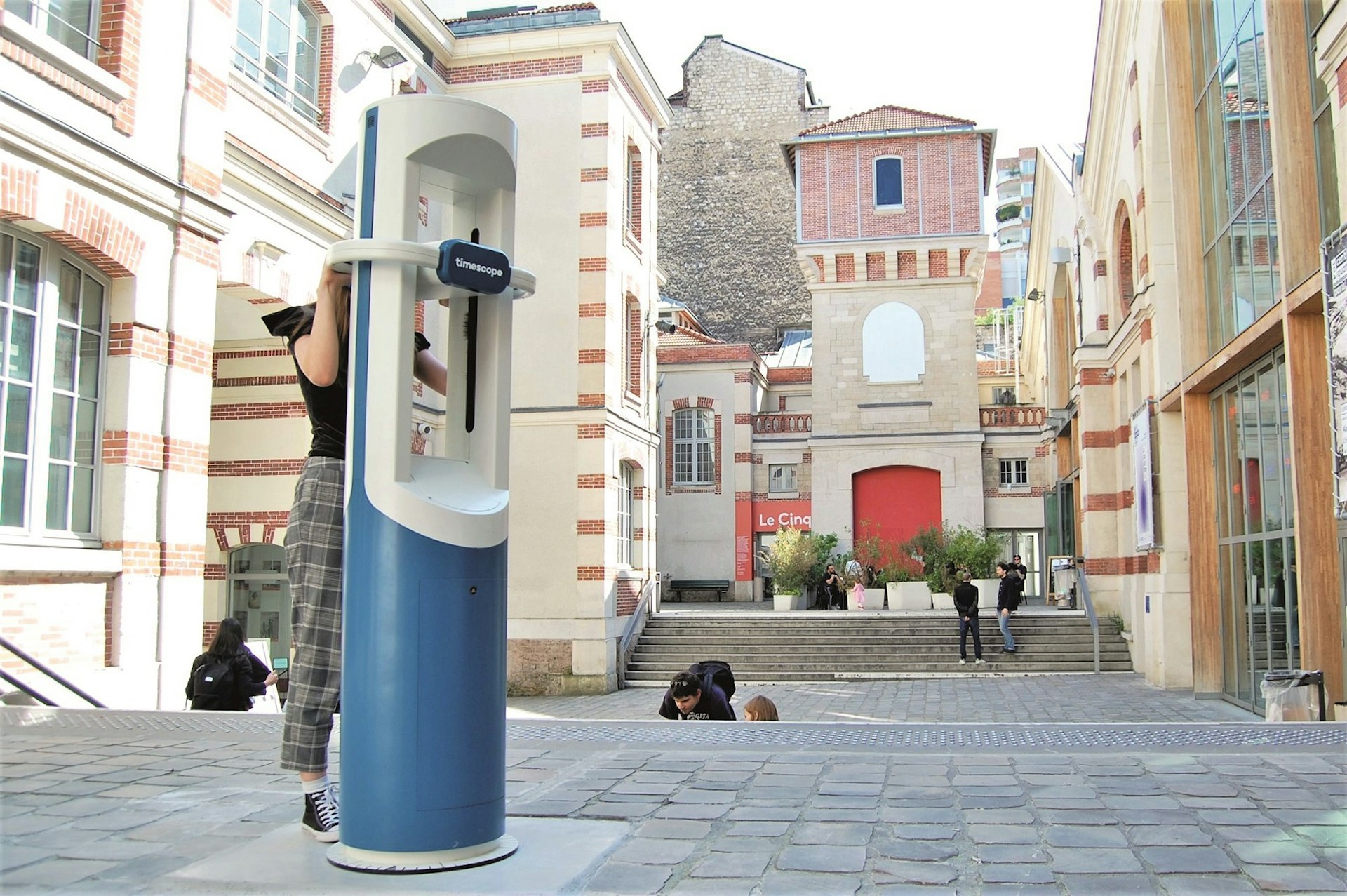 A woman looks through a Timescope VR viewer on a street in Paris © Photo courtesy of Timescope