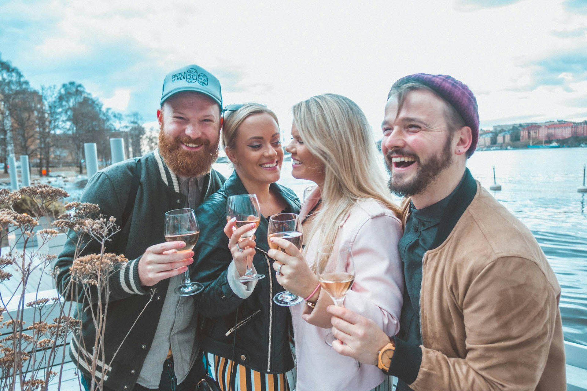 LGBT friends laughing and enjoying a glass of wine at floating bar Mälarpaviljongen © Megan & Whitney Bacon-Evans / Lonely Planet