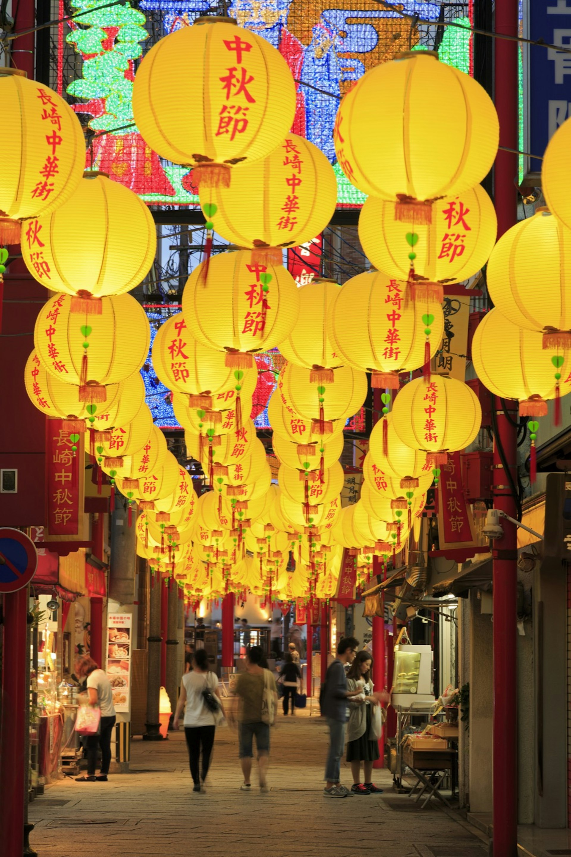 Colored lanterns illuminate a street in Nagasaki's Chinatown at night © Bruce Yuanyue Bi / Getty Images
