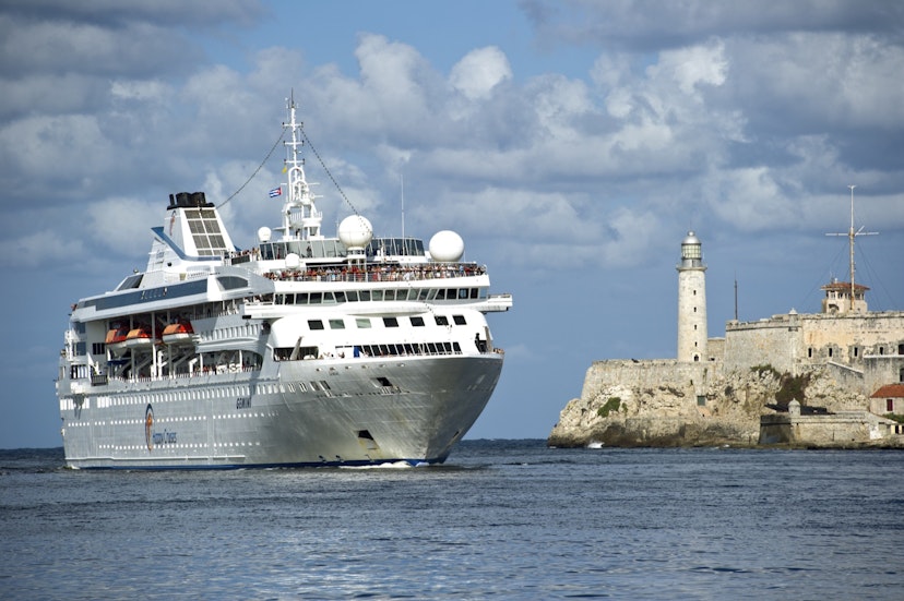 Features - Cruiseship entering Havana Harbour passing Morro Castle and lighthouse.