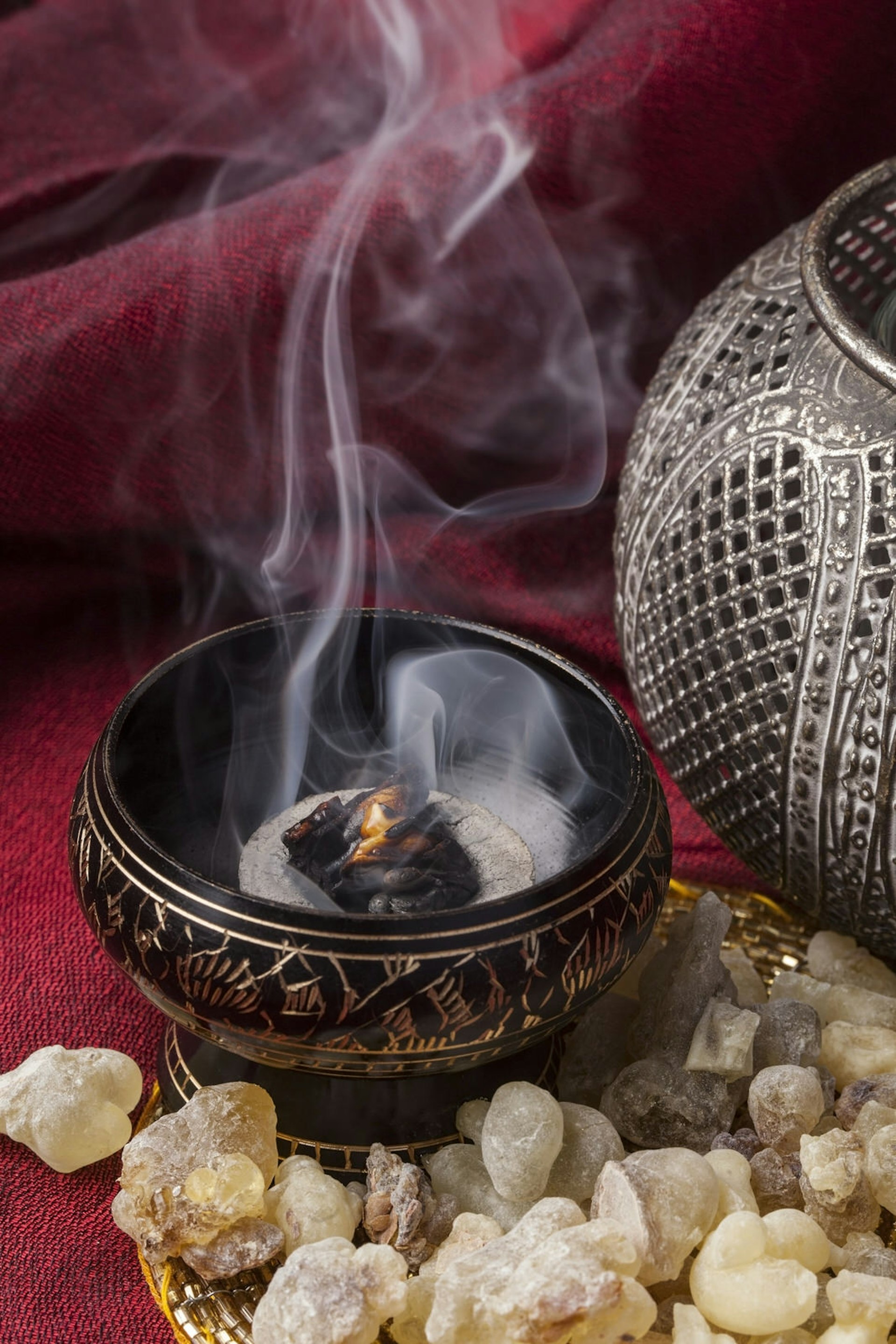 Frankincense burning on a hot coal. Frankincense is an aromatic resin, used for religious rites, incense and perfumes © JurateBuiviene / Shutterstock