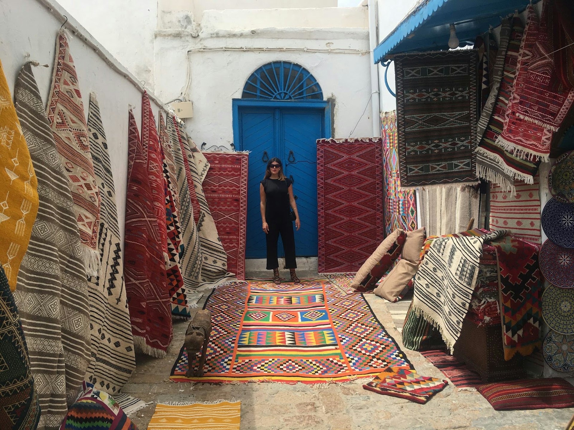 Erin shopping for traditional carpets in Sidi Bou Saïd © Erin Harvey / Lonely Planet