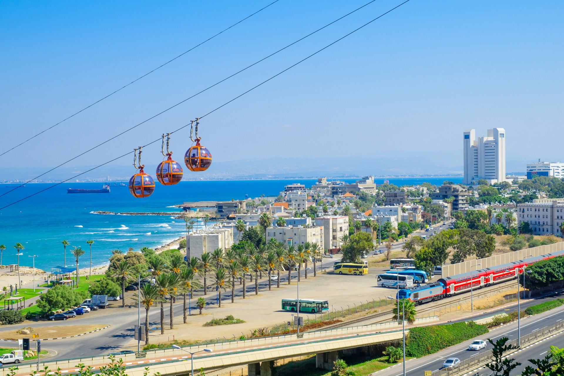 View of the bay, downtown and the cable car, with locals and visitors, in Haifa, Israel © RnDmS / Shutterstock