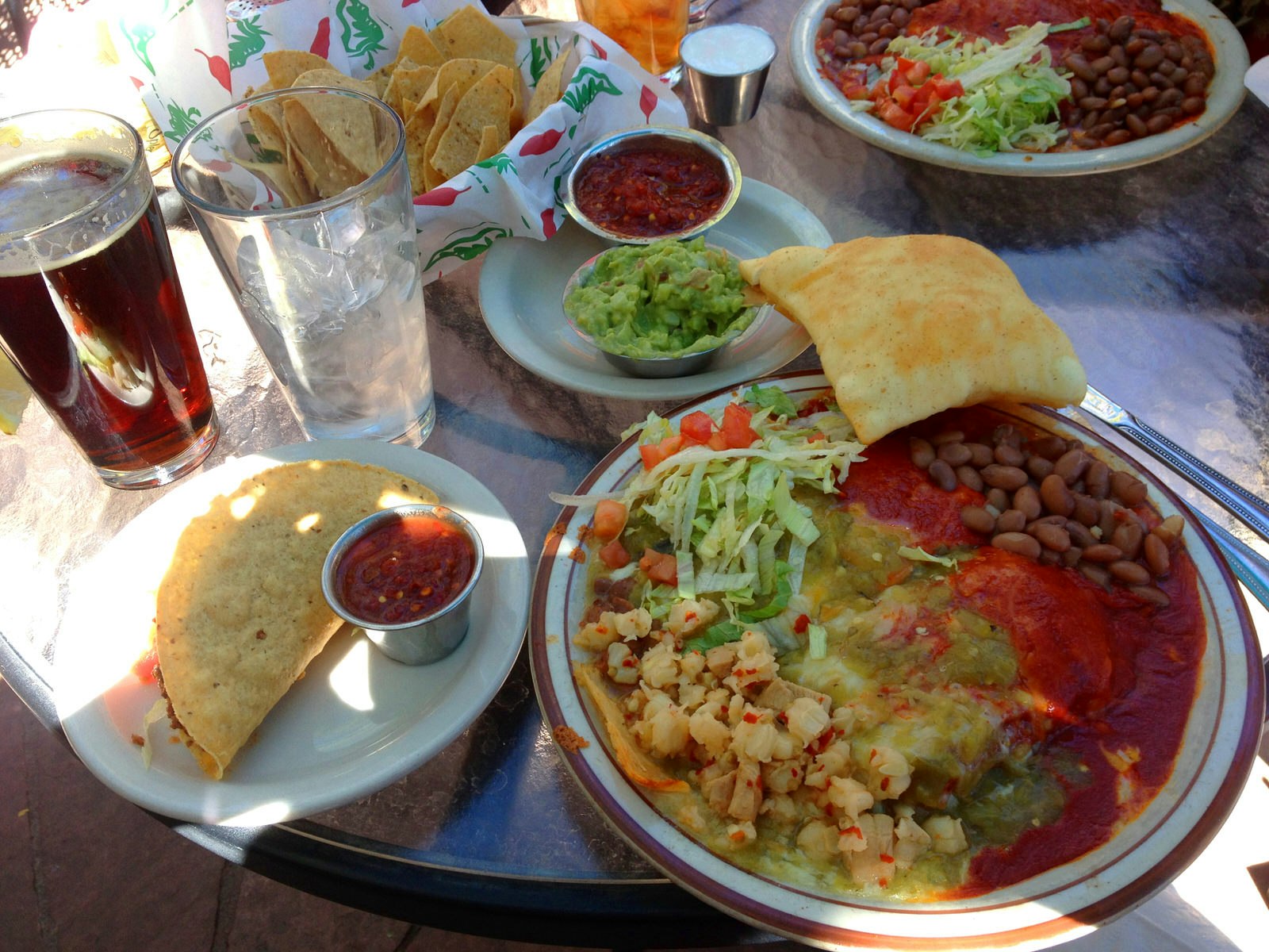 It's Christmas! A combination plate at La Choza in Santa Fe: red and green chile enchiladas, sopapillas, taco, salsa and a Santa Fe Brewing Company Nut Brown ale © Megan Eaves / Lonely Planet