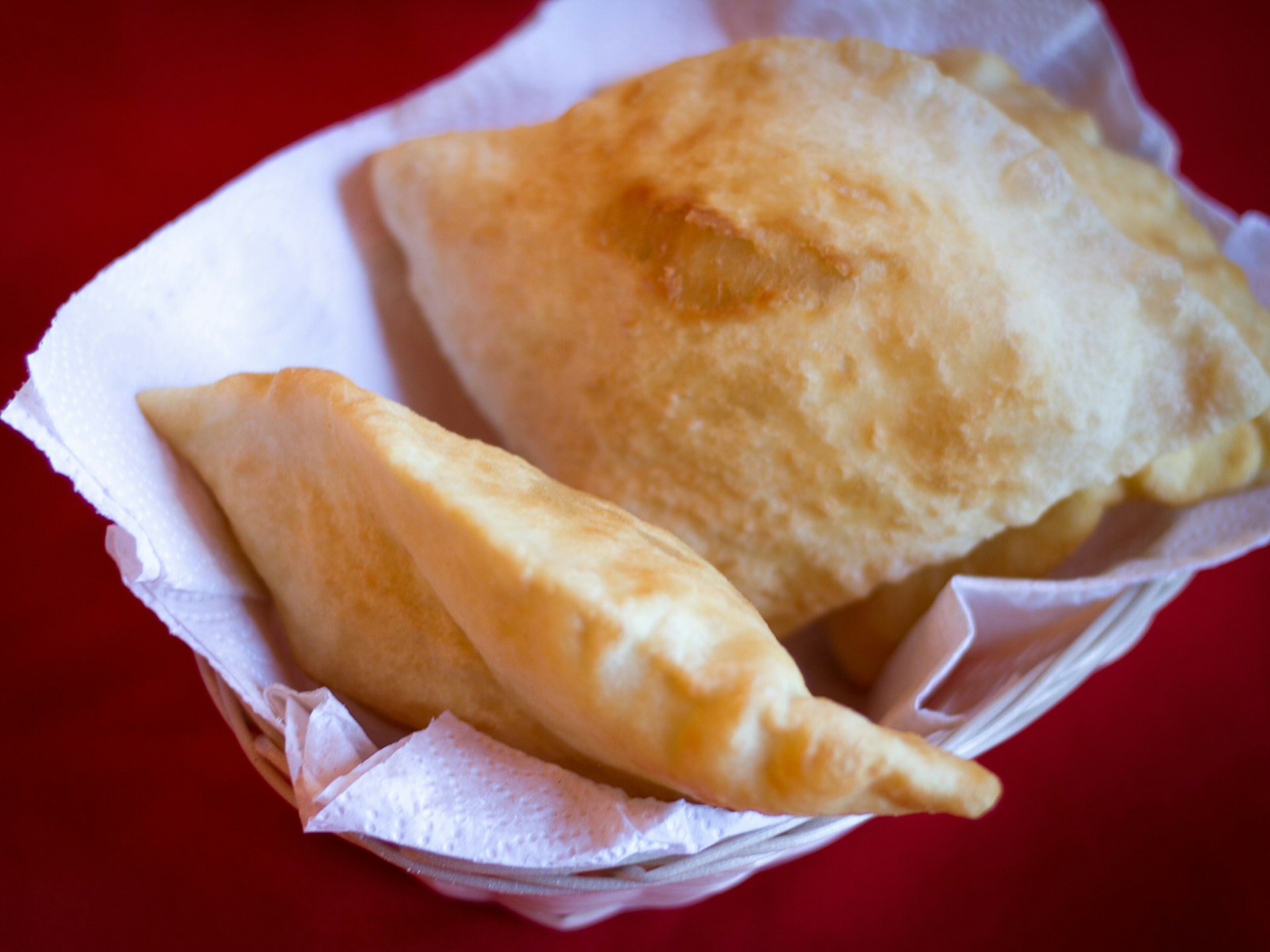 Sopapillas: fluffy fry bread normally eaten as a dessert with a drizzle of honey © JannHuizenga