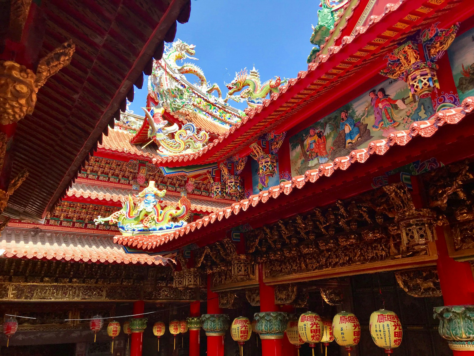 Colourful temple with upturned eaves, red tiled roofs, lanterns and multi-coloured dragon motifs. Lu'ermen Tianhou Temple in Tainan, Taiwan's oldest city, with colourful pottery and glass figurines © Piera Chen / Lonely Planet © Piera Chen / Lonely Planet