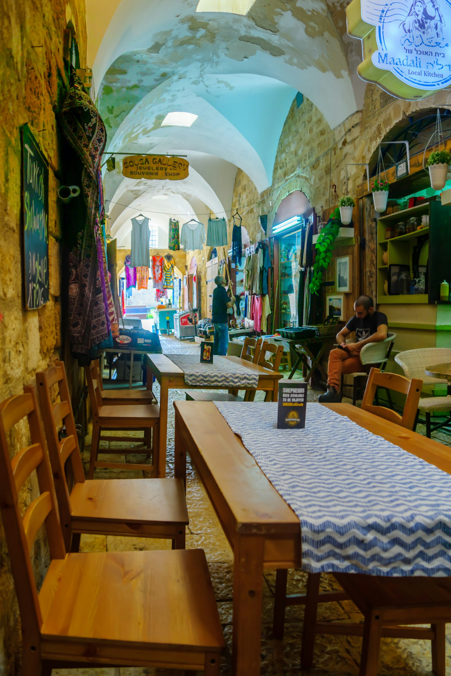 Scene of the Turkish Bazaar, with local businesses, locals and tourists, in the old city of Akko, Israel. It is a restored old covered market © RnDmS / Getty Images