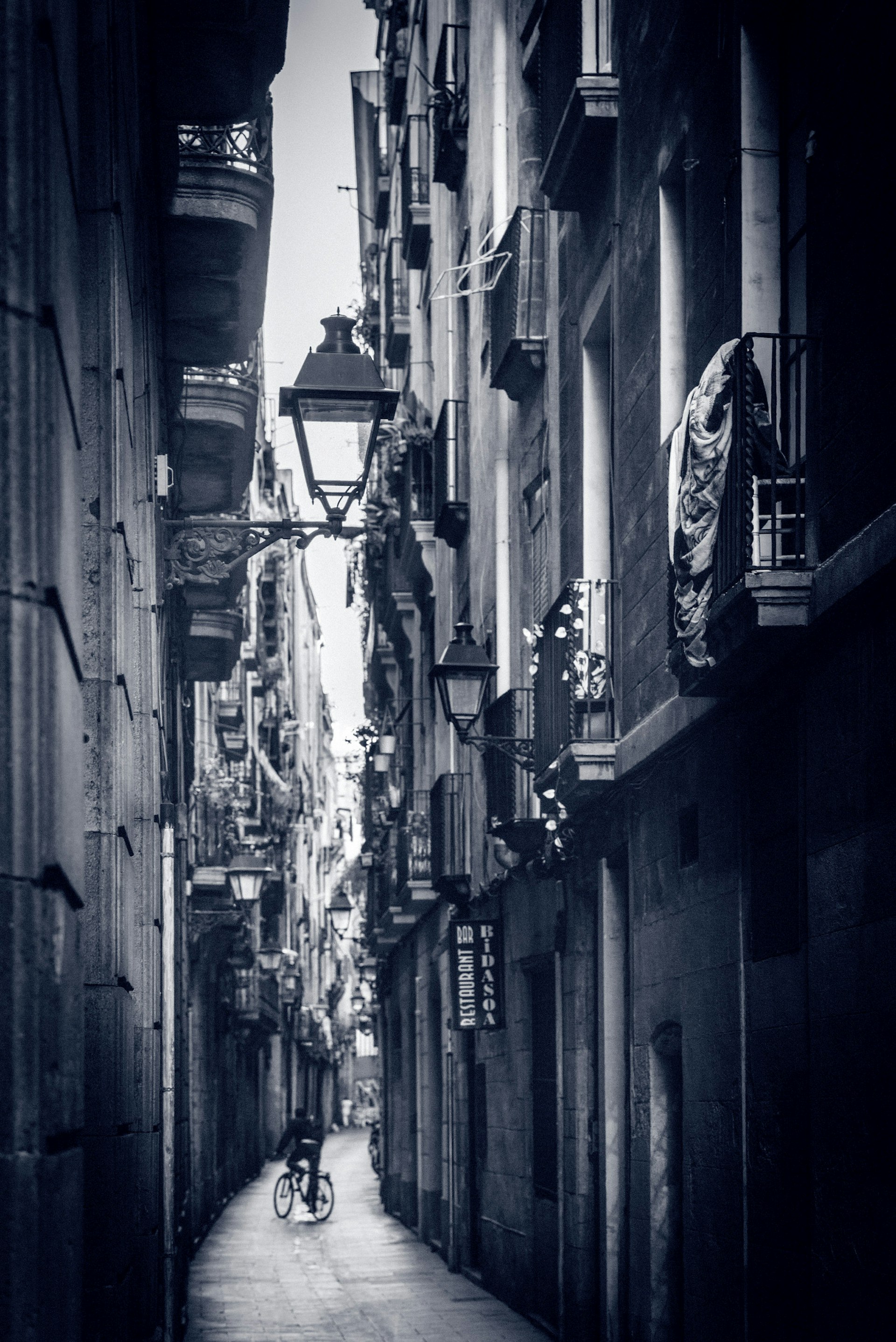 A black and white photo a street in the Barri Gotic © Jonathan Stokes / Lonely Planet