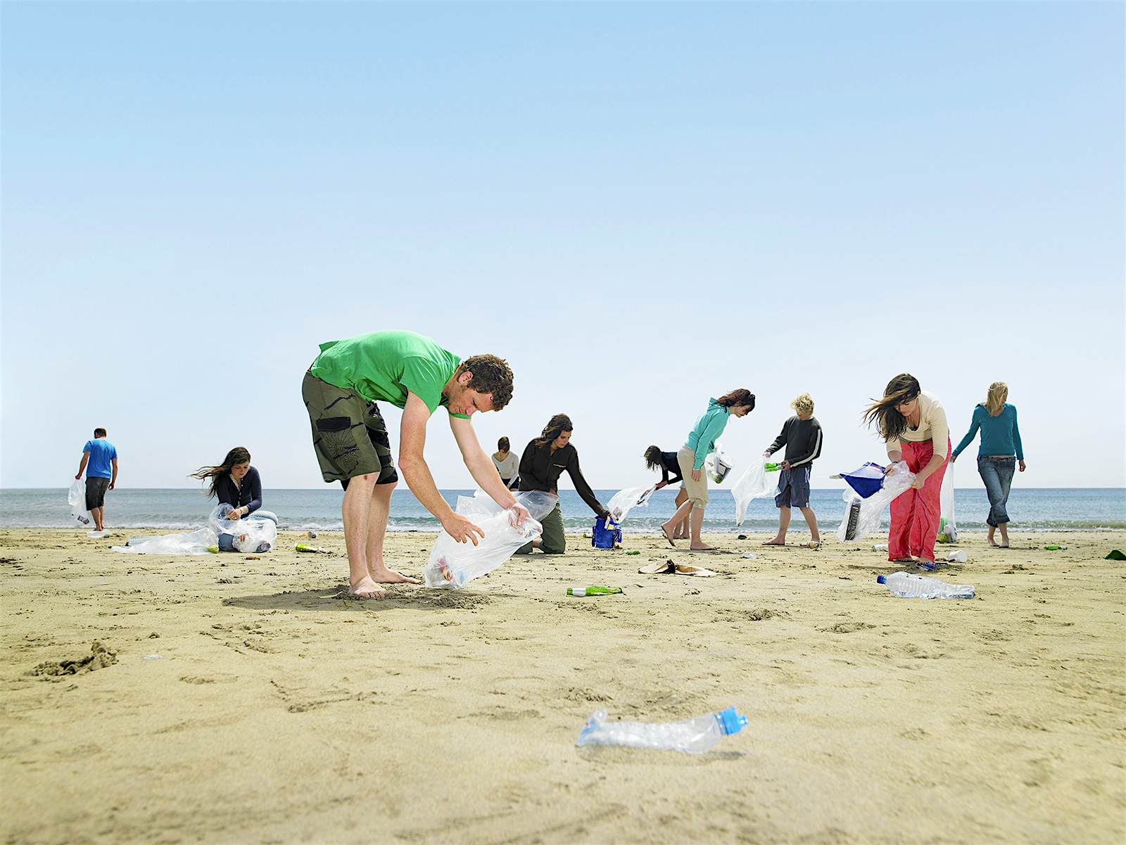 A group of young people clearing plastic from a beach in Cornwall, England © Frank and Helena / Getty Images