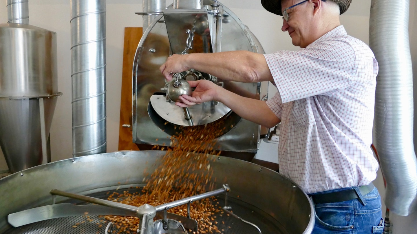 Miller Ilario Garbani roasting corn to make Farina Bóna (good flour) in Ticino, Switzerland © Sarah Gilbert / Lonely Planet