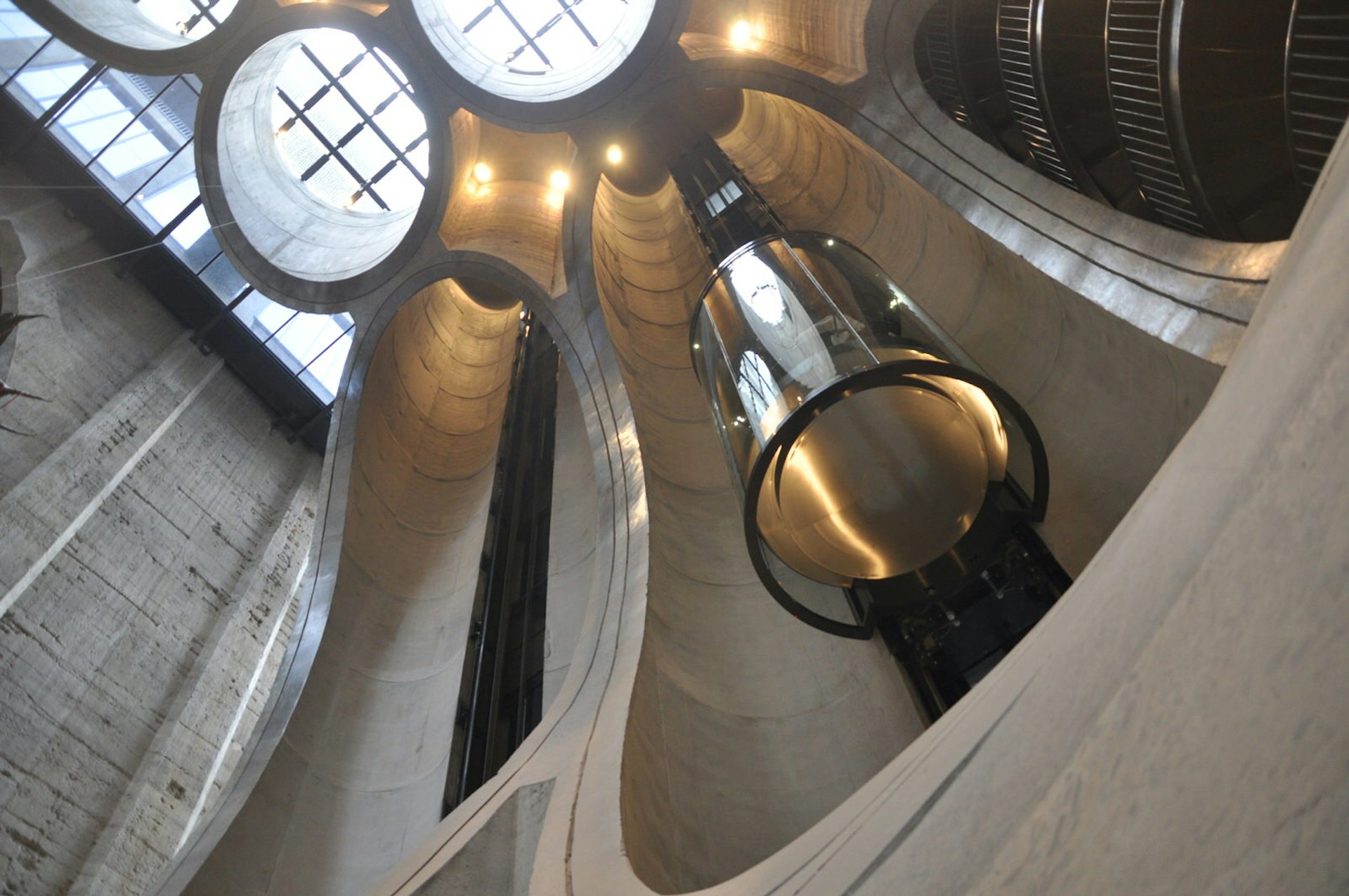 Looking skyward from the atrium of the Zeitz MOCAA – circular skylights, fill the ceiling, while the walls are scallop-shaped cross sections of the old concrete silos © Monica Suma / Lonely Planet