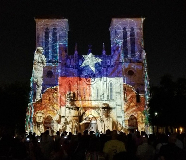 Scenes of San Antonio history, with the colors and star of the Texas flag, are projected on the front of a cathedral © Vicki Arkoff / Lonely Planet