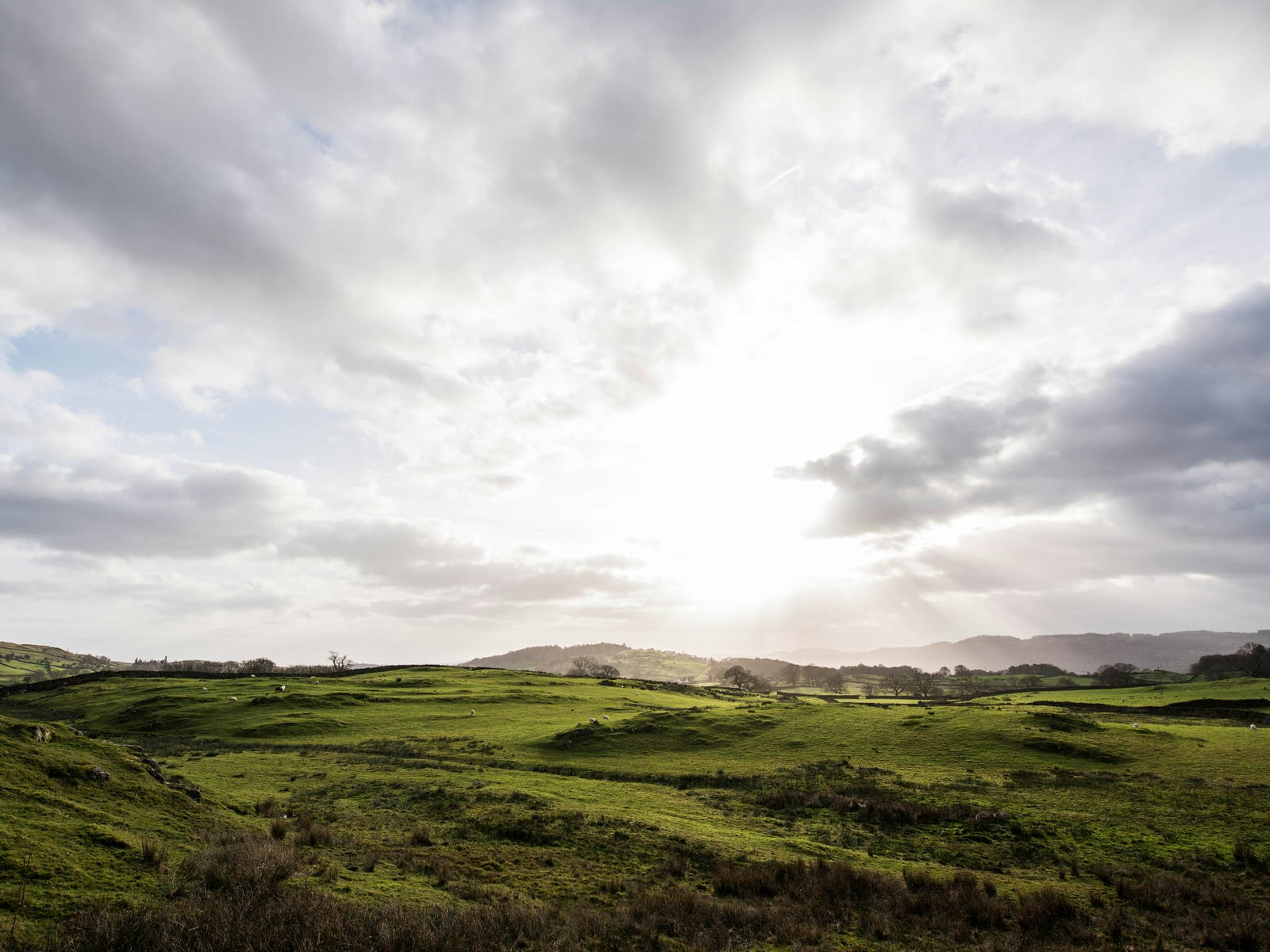 A wide shot of rolling green fields and the sun setting. Close to home: Chris still counts the English Lake District as one of his favourite places © Chris Sheldrick