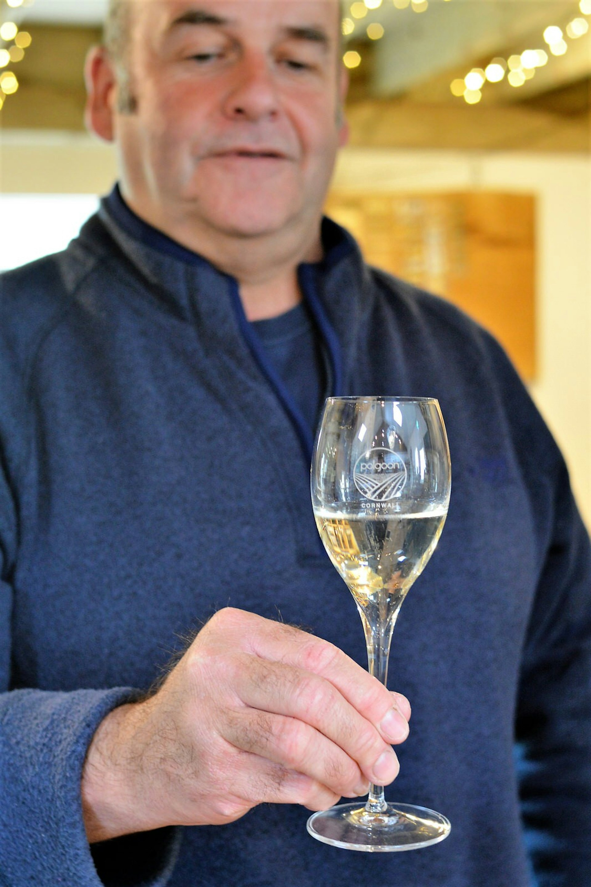 John, owner of Polgoon, admires one of his wines © Emma Sparks / Lonely Planet