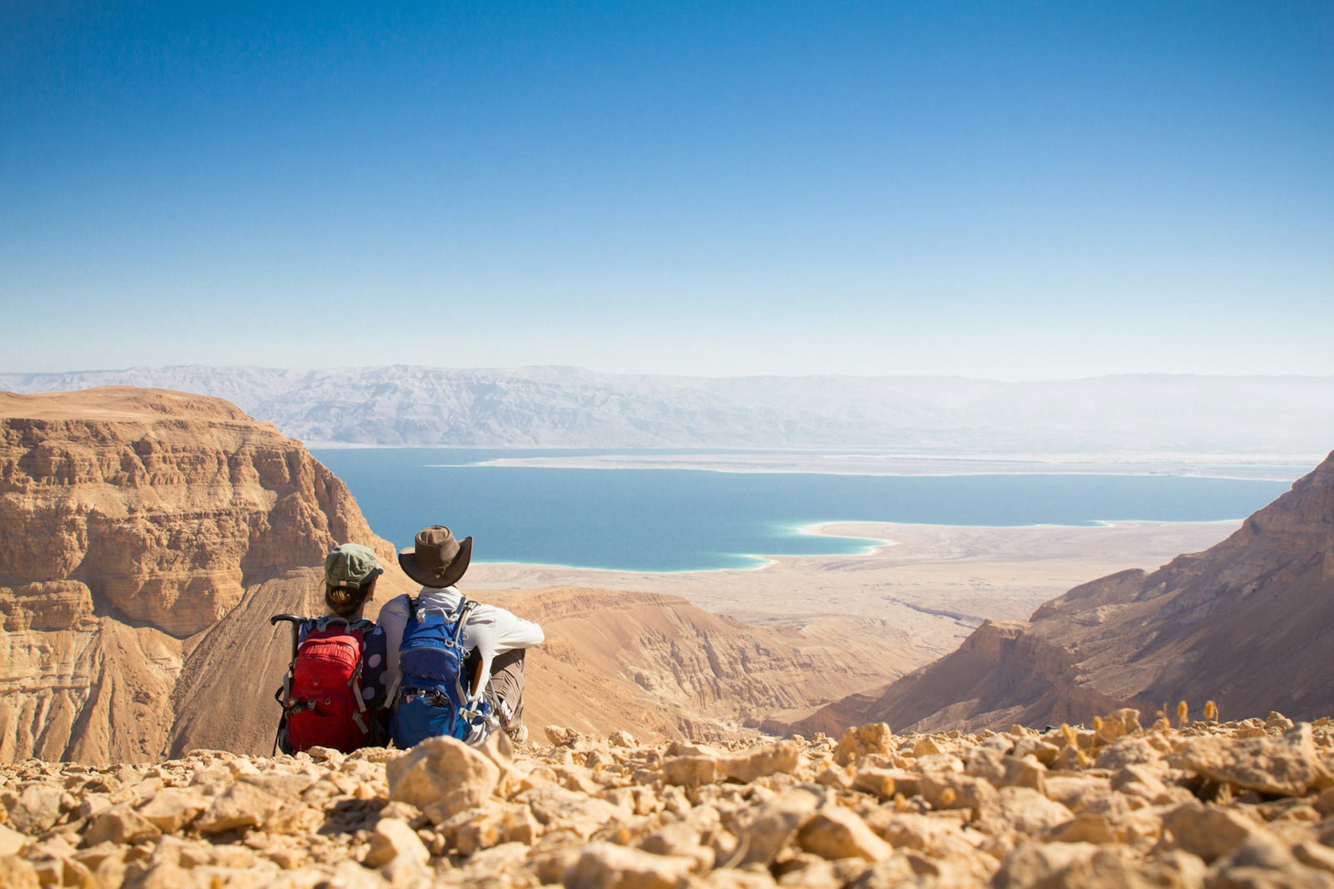 Hiking couple resting atop a mountain near Jordan's Dead Sea © Evgeny Subbotsky / Shutterstock