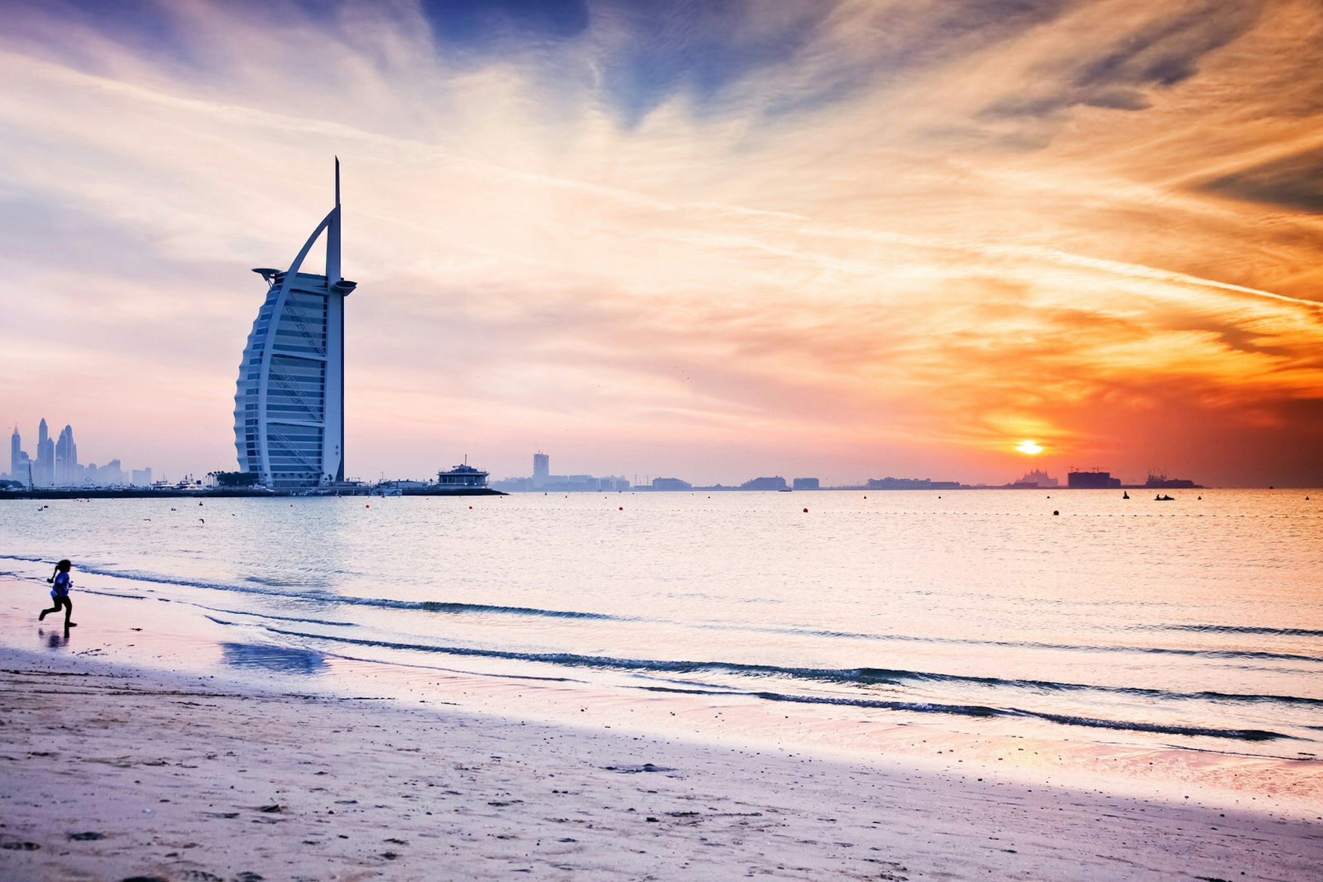 The world's first seven stars luxury hotel Burj Al Arab at sunset seen from Jumeirah public beach in Dubai, United Arab Emirates