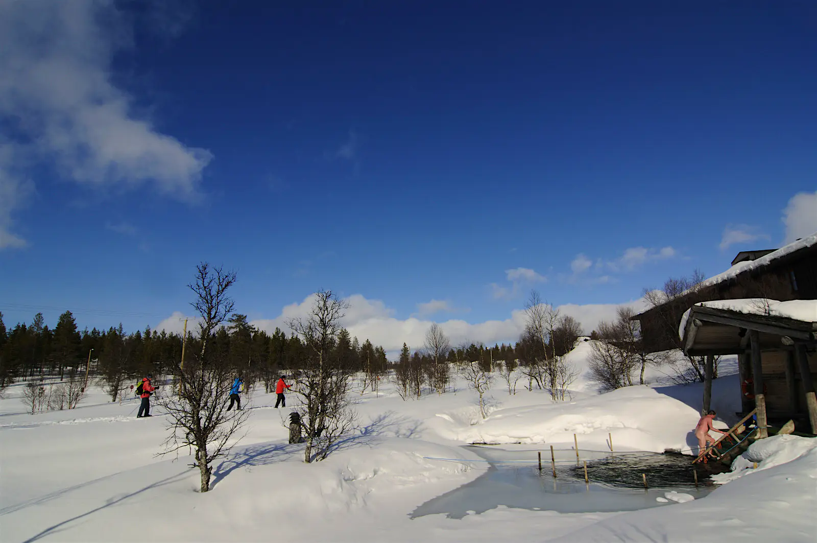 Sauna in Urho Kekkonen National Park A sauna-goer emerges after a plunge in icy water beside a steam sauna in Urho Kekkonen National Park, close to Saariselkä.