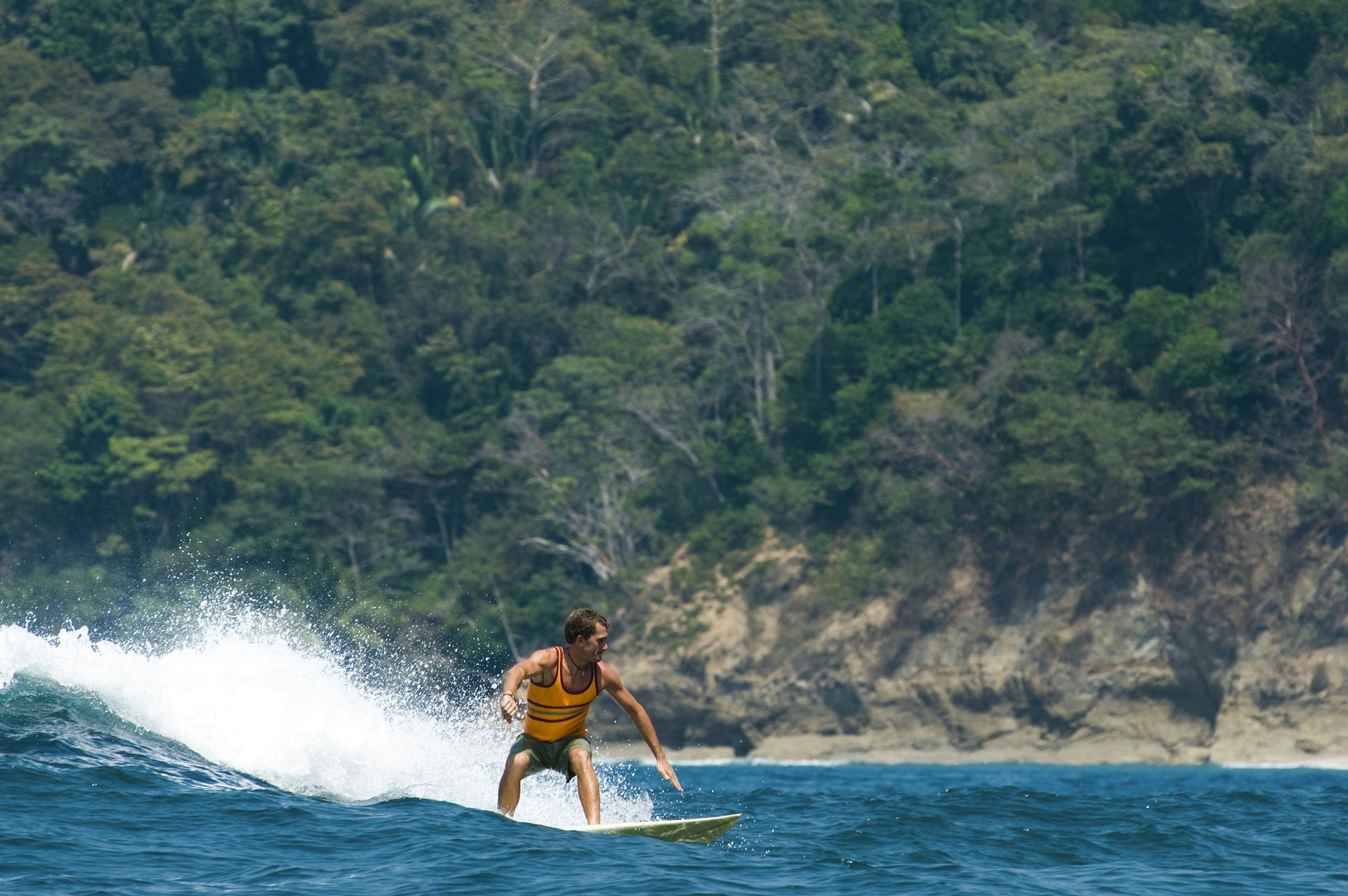 Features - A young man surfing in Costa Rica