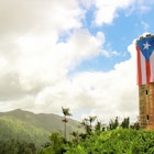 The Puerto Rican flag now proudly draped over Yokahú Observation Tower since the rainforest's reopening Mikol Hoffman / Lonely Planet