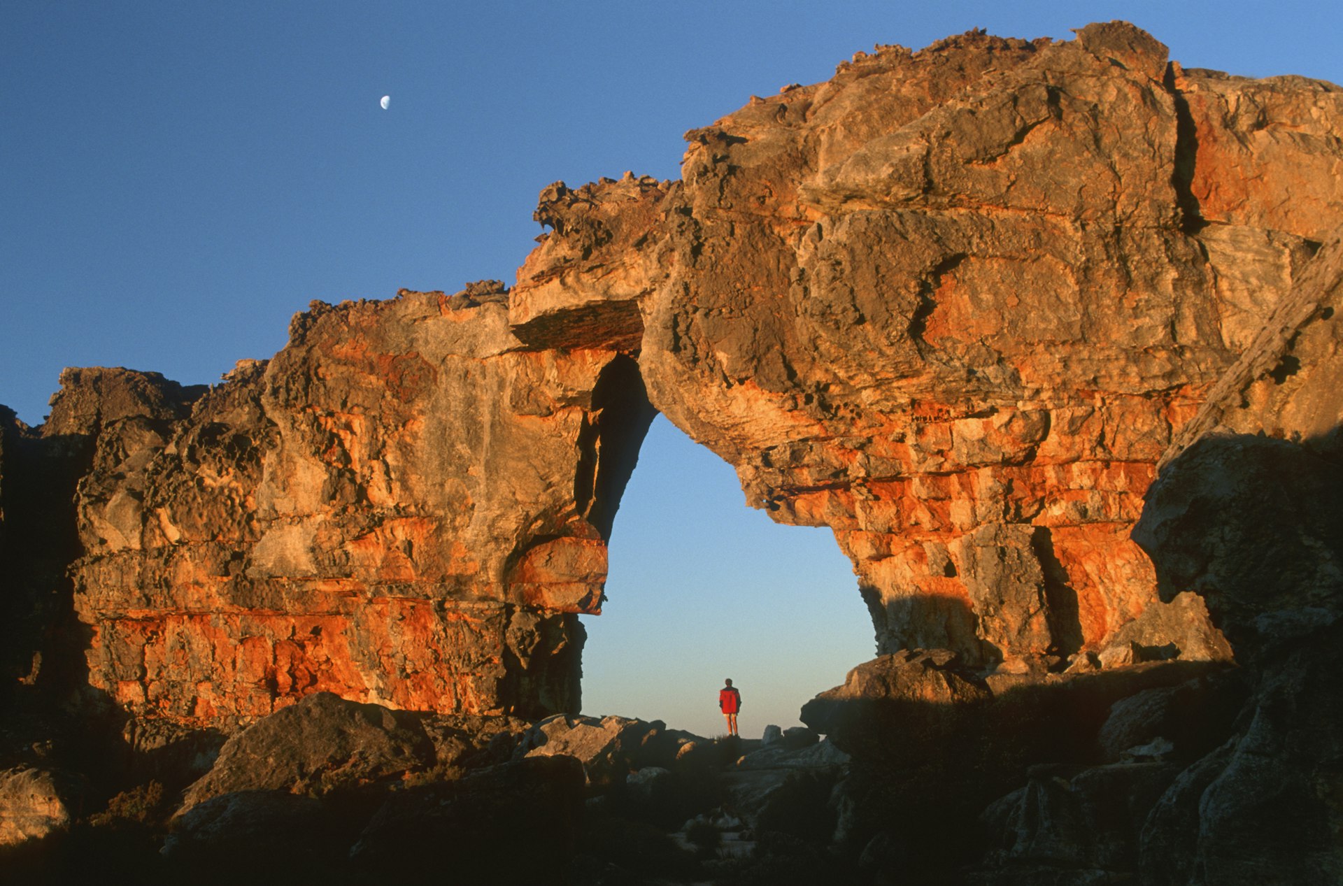 Features - Woman standing underneath rock arch, Wolfberg Arch, Cederberg, Western Cape Province, South Africa