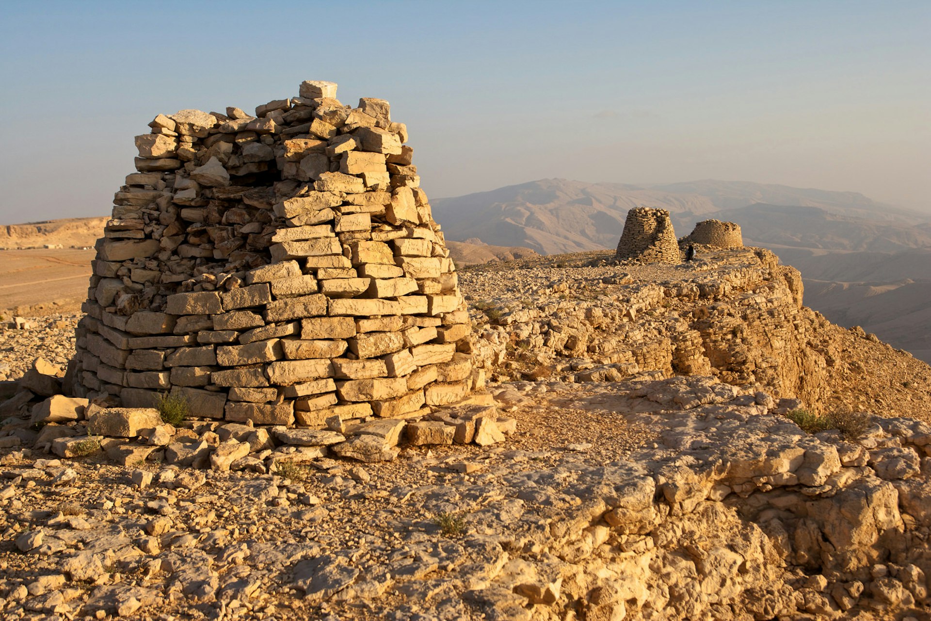 Lined up dramatically atop a rocky ridge, the Beehive Tombs of Bat, in Oman, are among the most unique ensemble of 4000-5000 year-old burial monuments, towers and remains of settlement in the Arabian Peninsula. They are a Unesco World Heritage Site © ZambeziShark / Getty Images