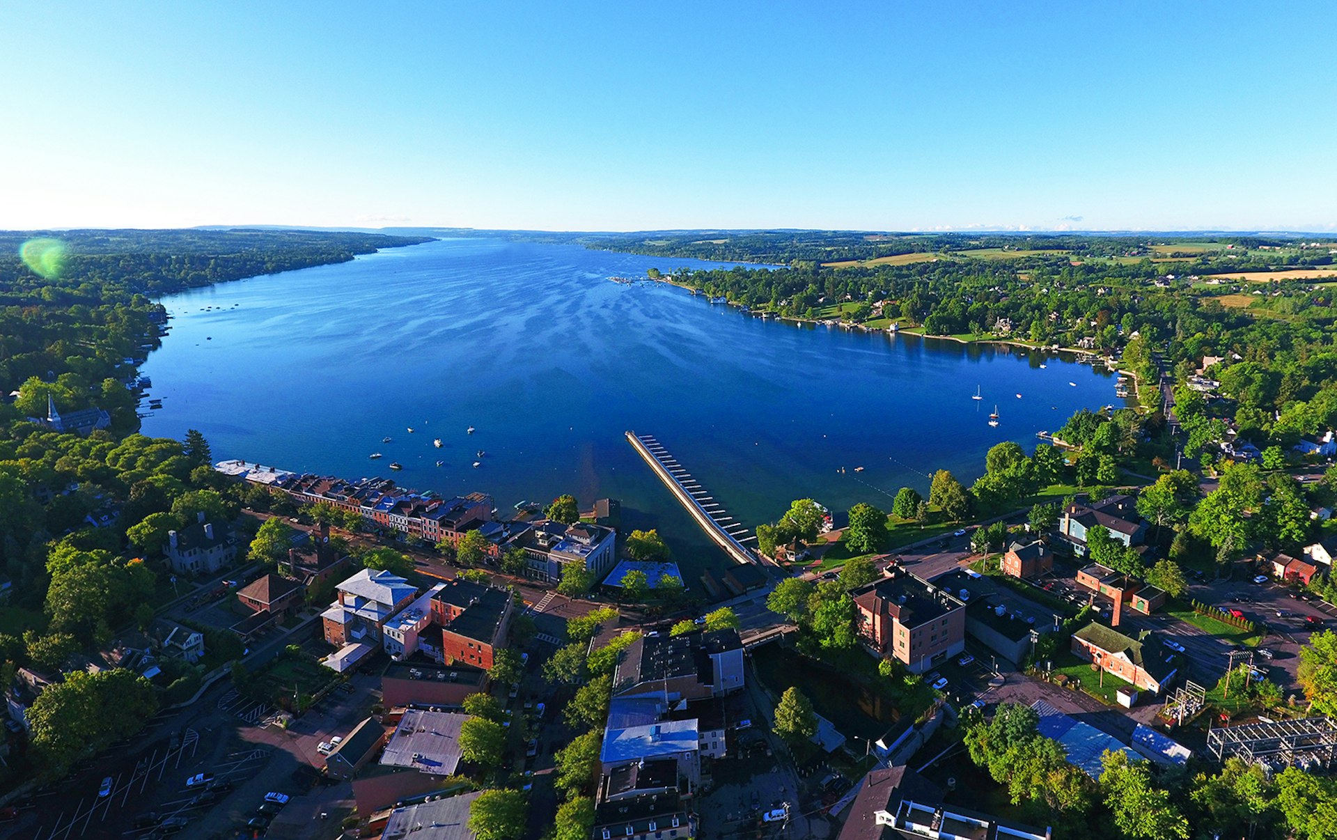 Aerial of Skaneateles Lake and Village on a sunny day with blue skies and green trees © Matt Champlin / Getty Images