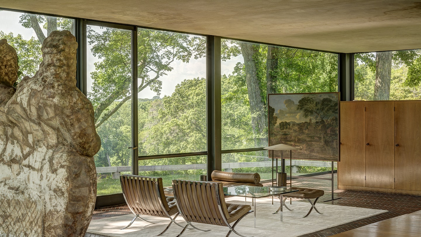Wide interior shot of Glass House with mid-century modern furnishings on a white rug © Michael Biondo
