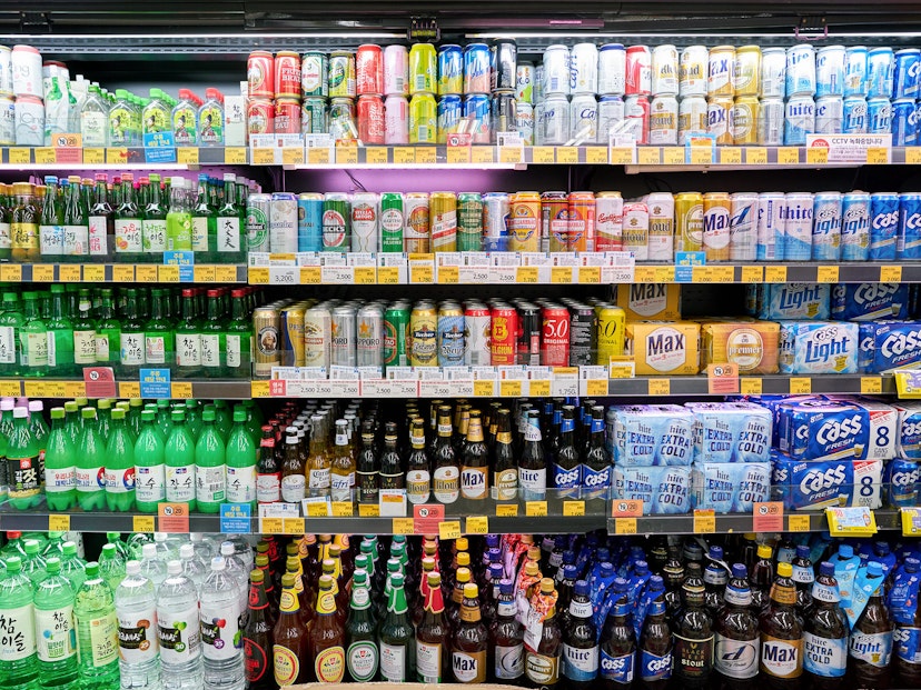 A fridge full of multi-coloured bottles of soda, beer and soju. Convenience stores like CU (pictured) a popular party spots and a good place to drink on the cheap © Sorbis / Shutterstock