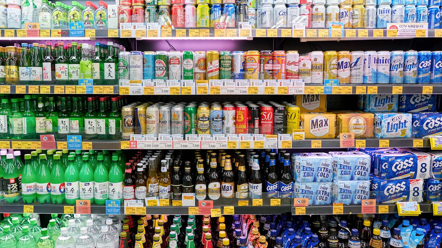 A fridge full of multi-coloured bottles of soda, beer and soju. Convenience stores like CU (pictured) a popular party spots and a good place to drink on the cheap © Sorbis / Shutterstock