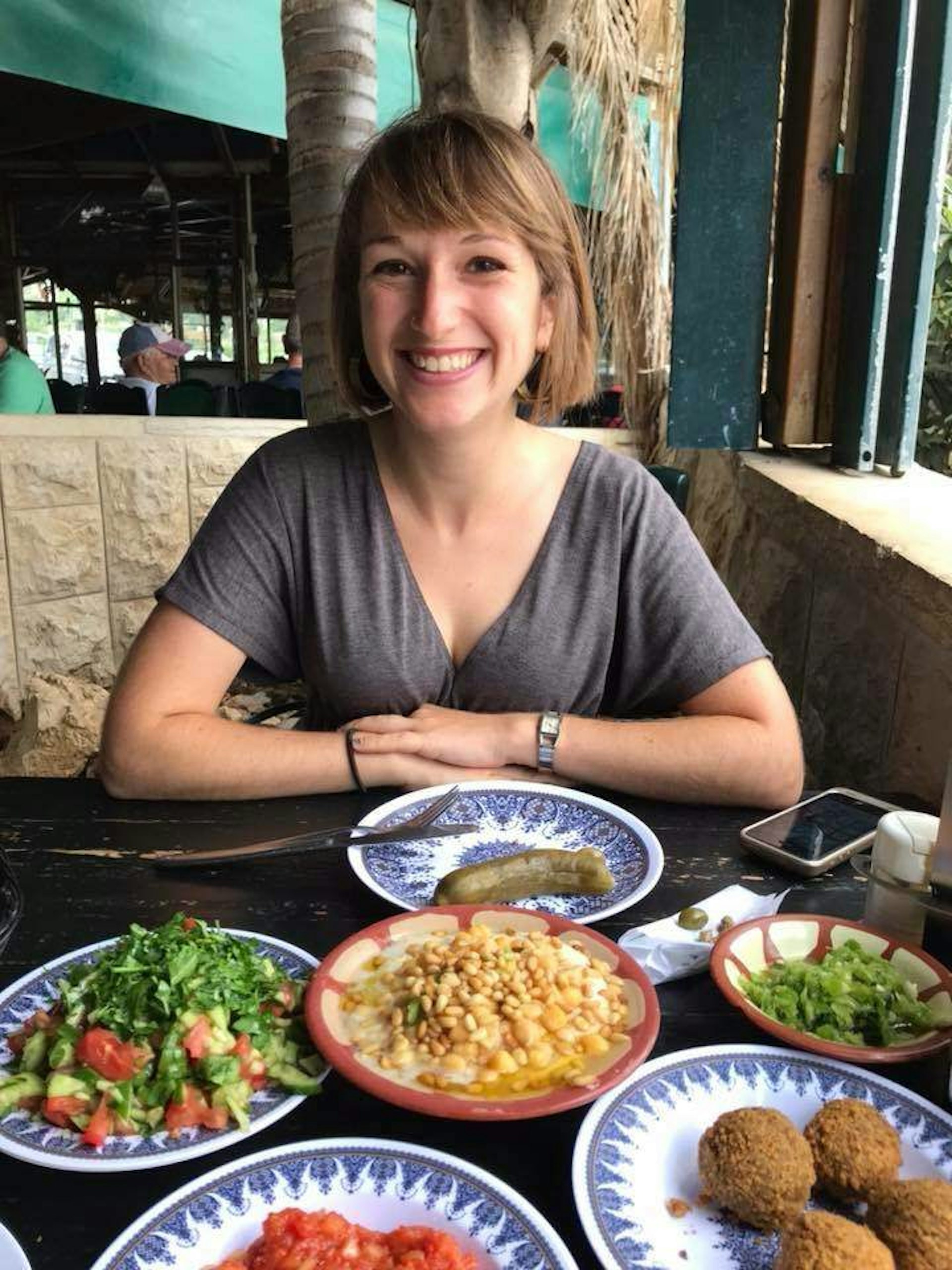 Writer Miriam Berger eating falafel, salad and hummus in Jerusalem