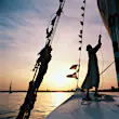 Egypt, Aswan, man sailing felucca on the River Nile at sunset © Nicholas Pitt / Getty Images