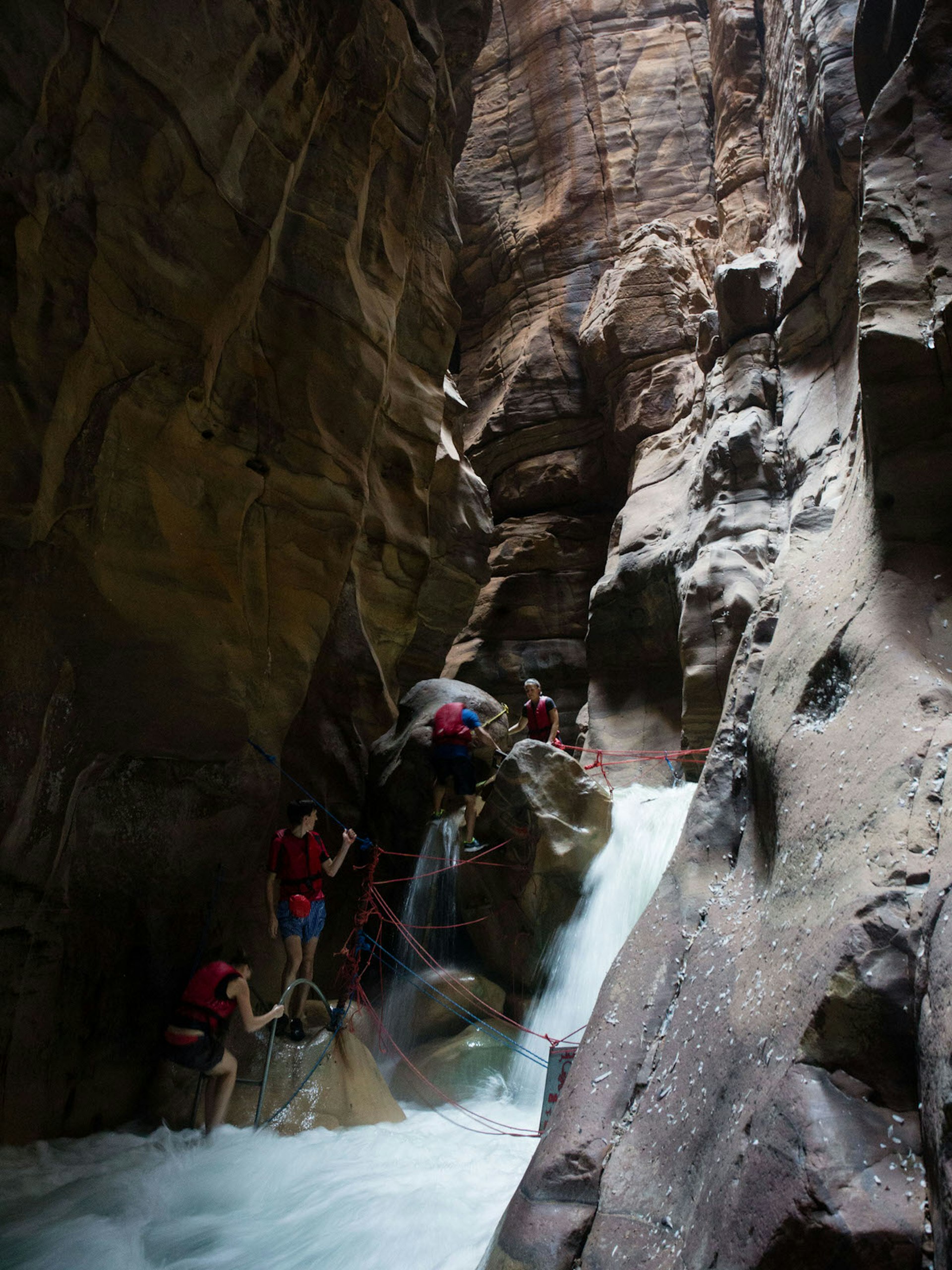 Hikers climbing through Wadi Mujib Siq, Dead Sea, Jordan © Stephen Lioy / Lonely Planet