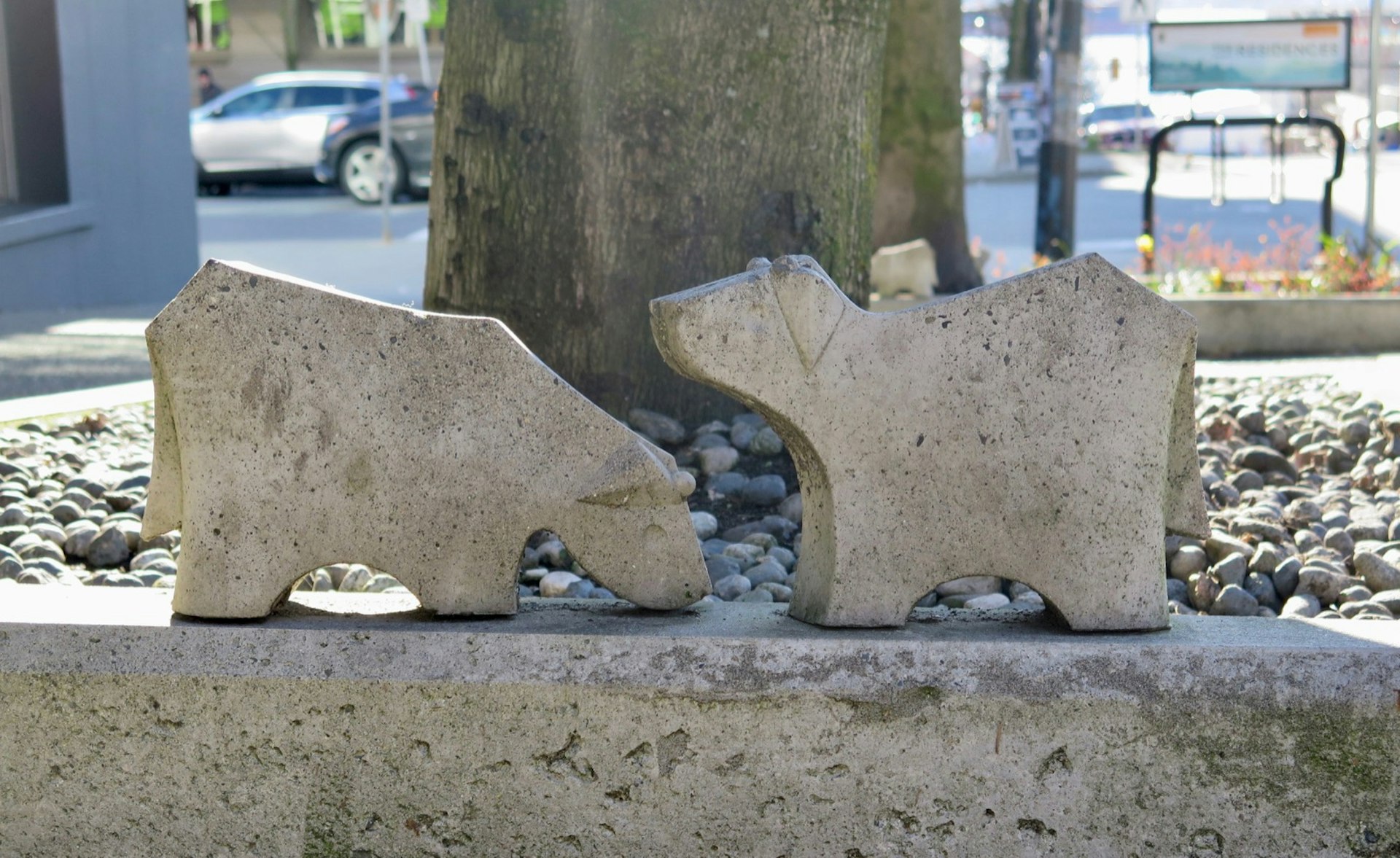 Small concrete cows sit on a stone block © John Lee / Lonely Planet