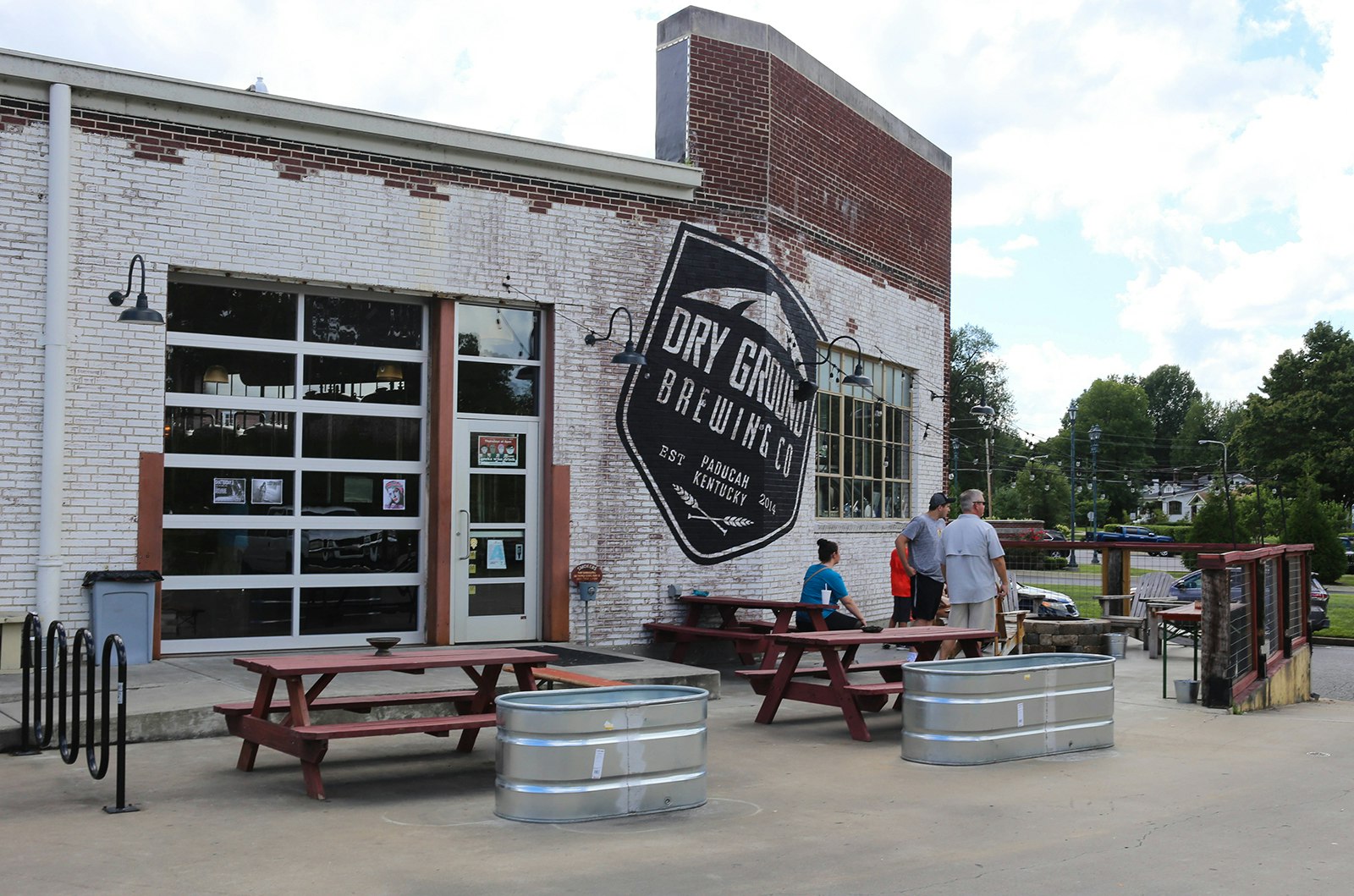 Exterior view of old industrial building reconfigured into a brewery on a partly cloudy day