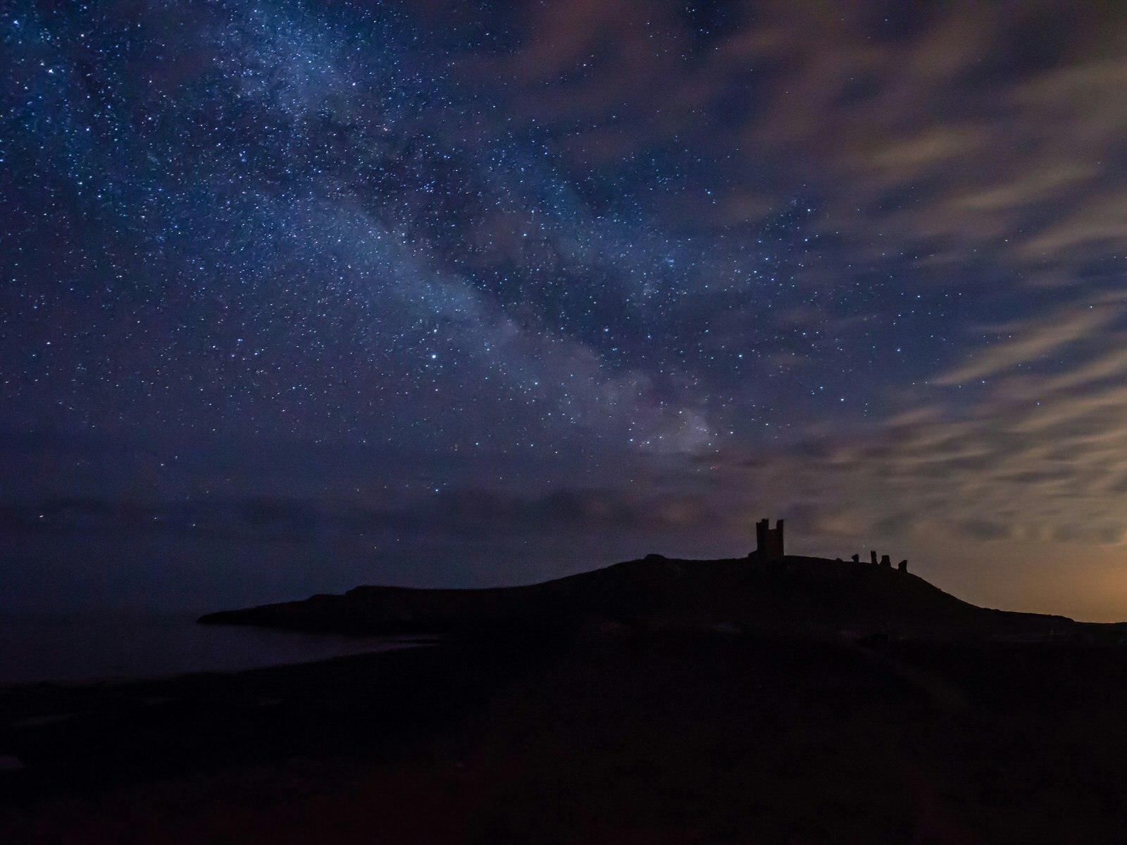 The night sky at Dunstanburgh Castle in Northumberland National Park, an IDA-designated dark sky park 