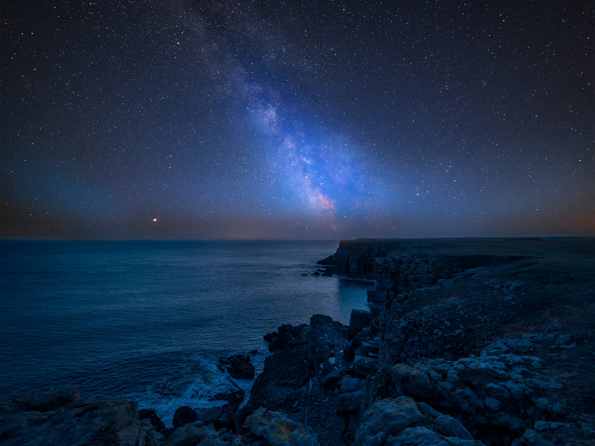 The Milky Way streaking above St Govan's Head on Pembrokeshire Coast in Wales 