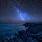 The Milky Way streaking above St Govan's Head on Pembrokeshire Coast in Wales © Matt Gibson / Shutterstock