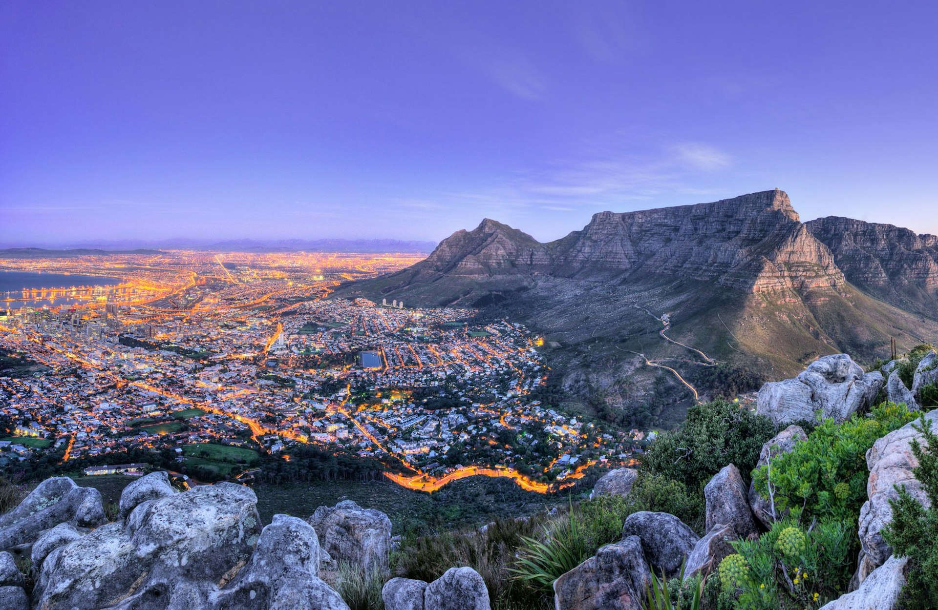 A panoramic view of Cape Town, showing mountains, city and the sea