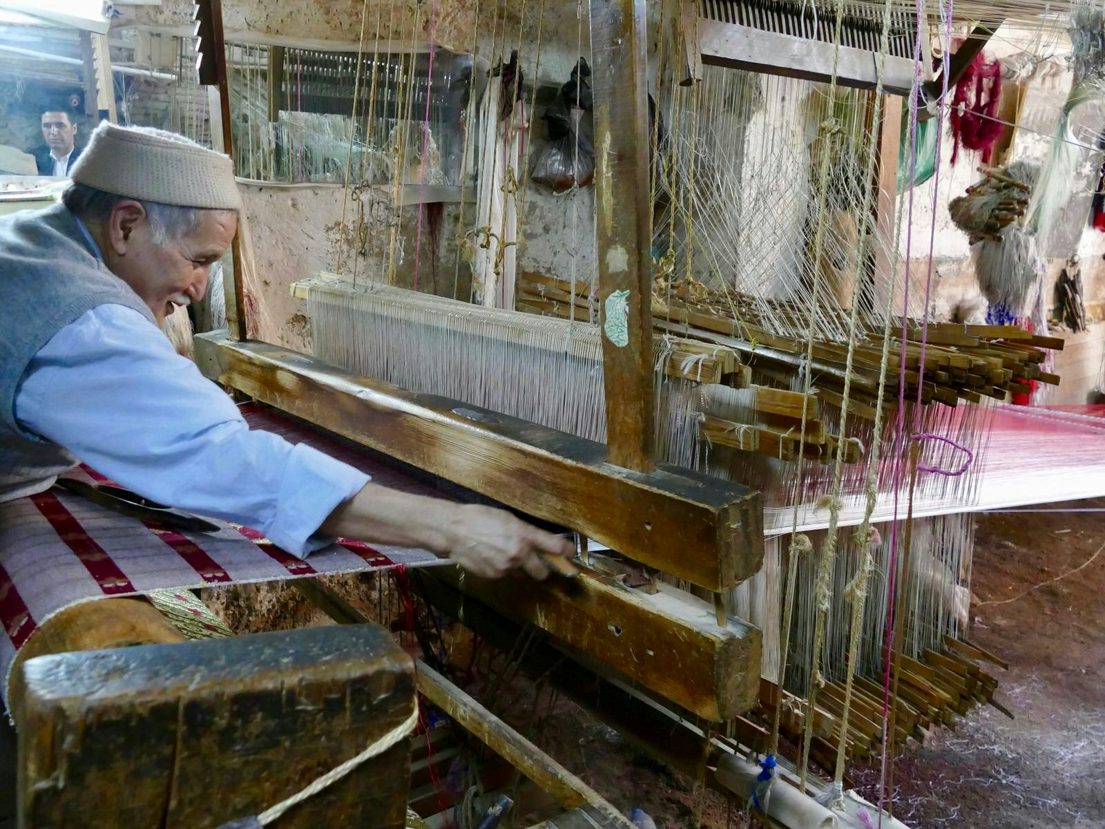 Abdelkhader El Ouazzani works at his loom, which travellers can watch as part of the Culture Vultures tour in Fez, Morocco